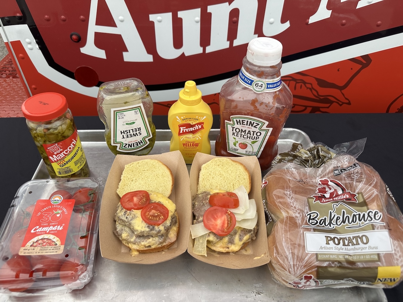 Aunt Millie's Bakehouse Potato Hamburger Buns with cheeseburgers and condiments