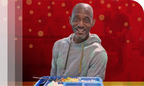 Man with a meal at The Mission.